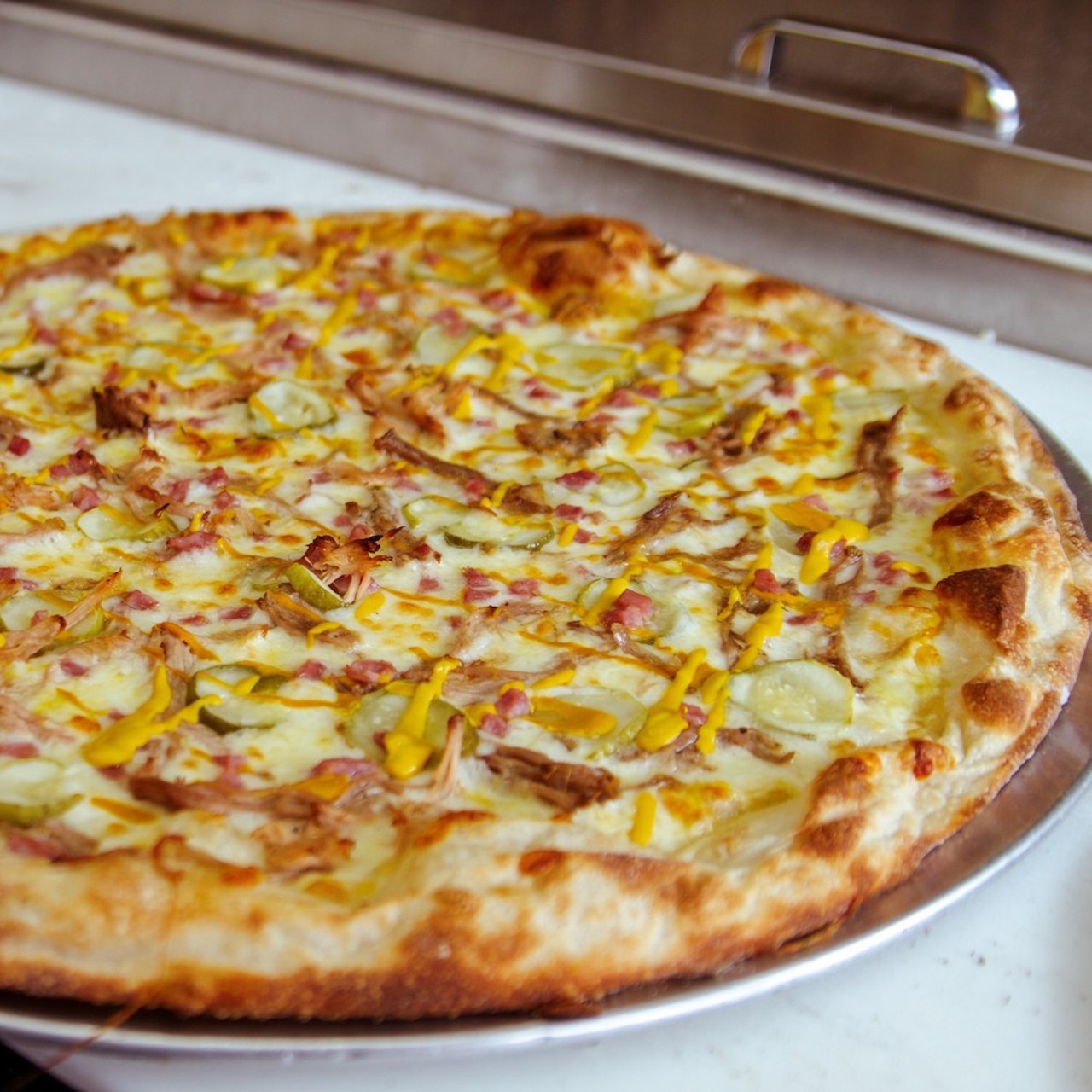 Cuban Pizza
Pizza Emporium tops its Dijonnaise base with a mozzarella and Swiss blend &#151; plus roast pork, ham and pickles &#151; to present an oh-so-Tampa pie.