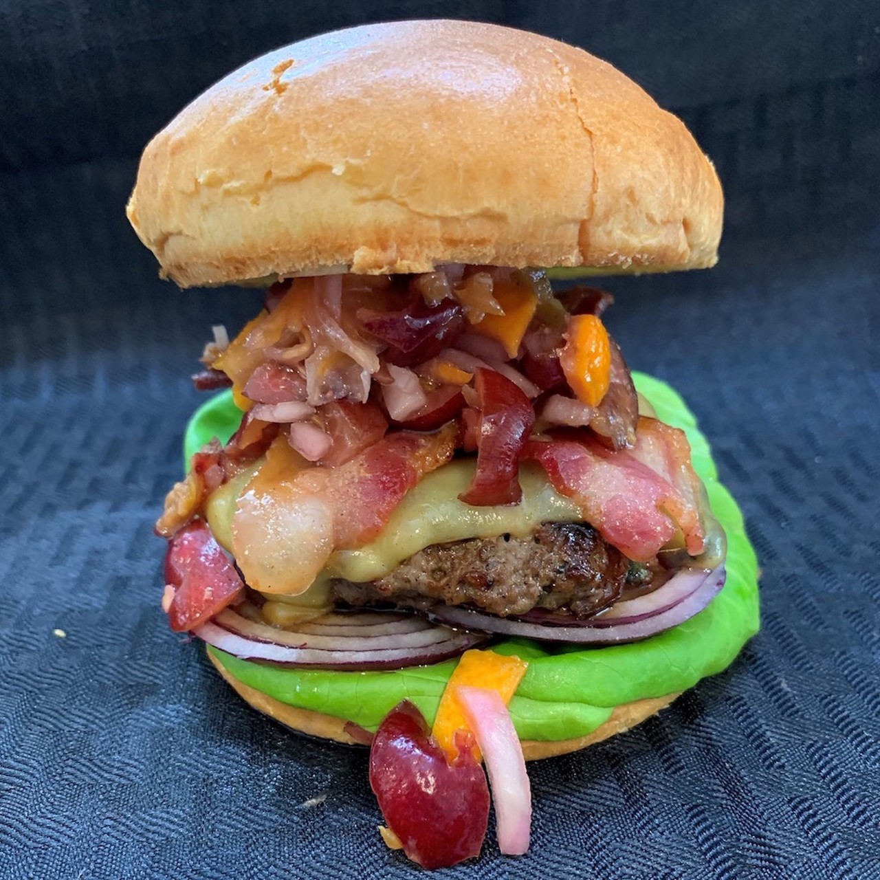 Black Cherry Burger
Carousel Foods uses cherries, basil, shallots and garlic to construct one big patty stacked with two slices of bacon, Gouda and cherry-orange relish on a toasted brioche bun.