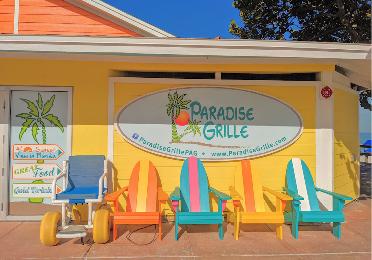 Paradise Grille 
6850 Beach Plaza, St. Pete Beach, 727-560-5399
This restaurant couldn’t be any closer to the water with tables just steps away from the water. Make sure to wear sunscreen as it doesn’t offer indoor seating. Paradise Grill offers classic American treats and a wide selection of drinks to choose from while enjoying a family beach day. 
Photo via Paradise Grille/Facebook