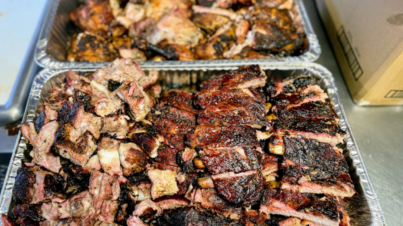 Bruh Mans BBQ
2702 E Busch Blvd., Tampa
In the shadow of rollercoasters and open on weekends only, Cory Taylor's Bruh Man's barbeque is a roadside must-try off Tampa’s bustling Busch Boulevard. His team slings classic sides and meats—including two-meat combo plates that could feed three people—all cooked in a pair of gigantic smokers behind Bruh Man's food truck trailer and adjacent free standing kitchen. The no-frills, parking lot outdoor dining room is underneath a giant car wash cover and soundtracked by a booming sound system that bumps the classic hip-hop of today (read: Travis Scott, 2 Chainz, Mike Jones).
Photo via Google Maps