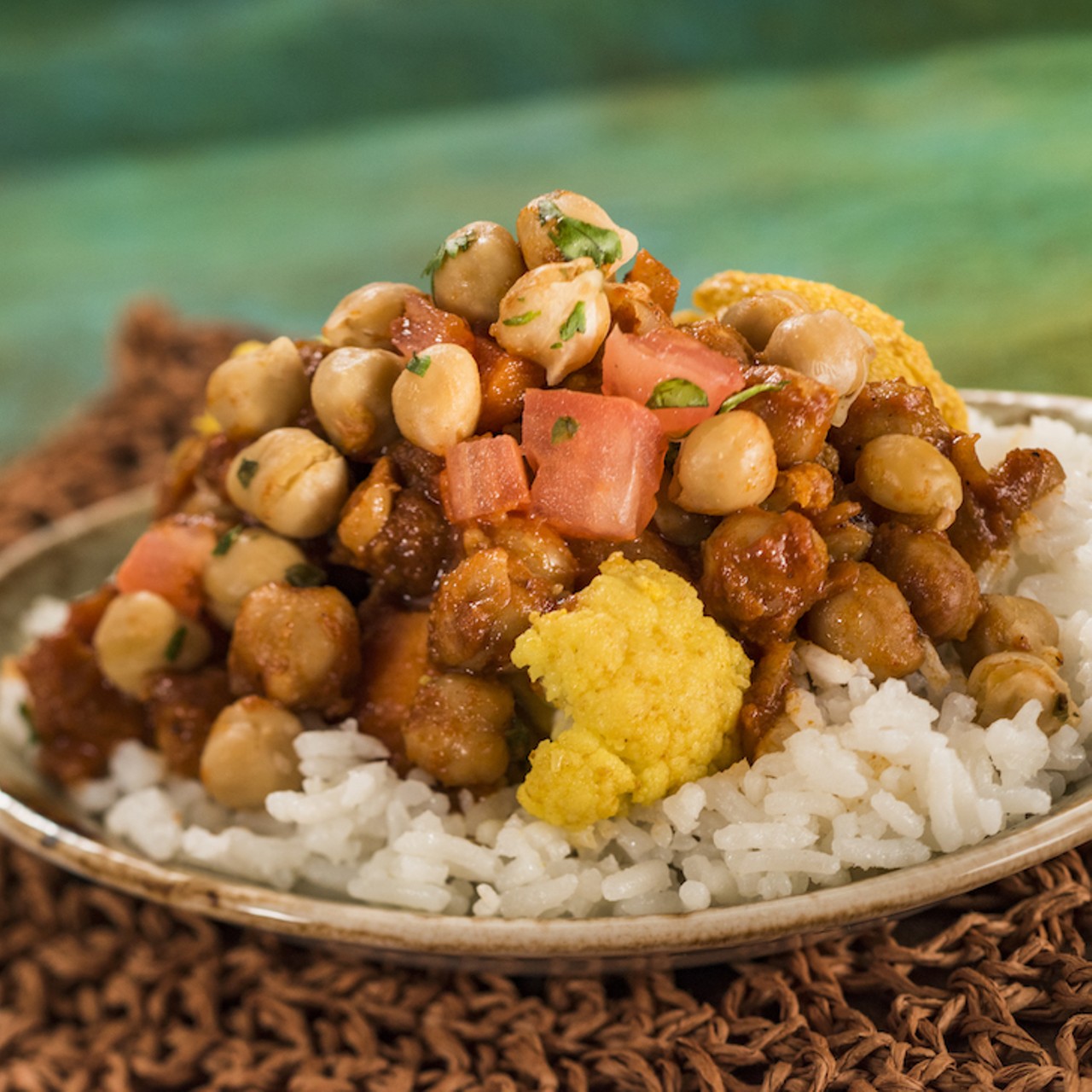 In India, sample the madras red curry. Curry lovers, you know what this vegan dish has in it: roasted cauliflower, baby carrots, chickpeas and basmati rice.
