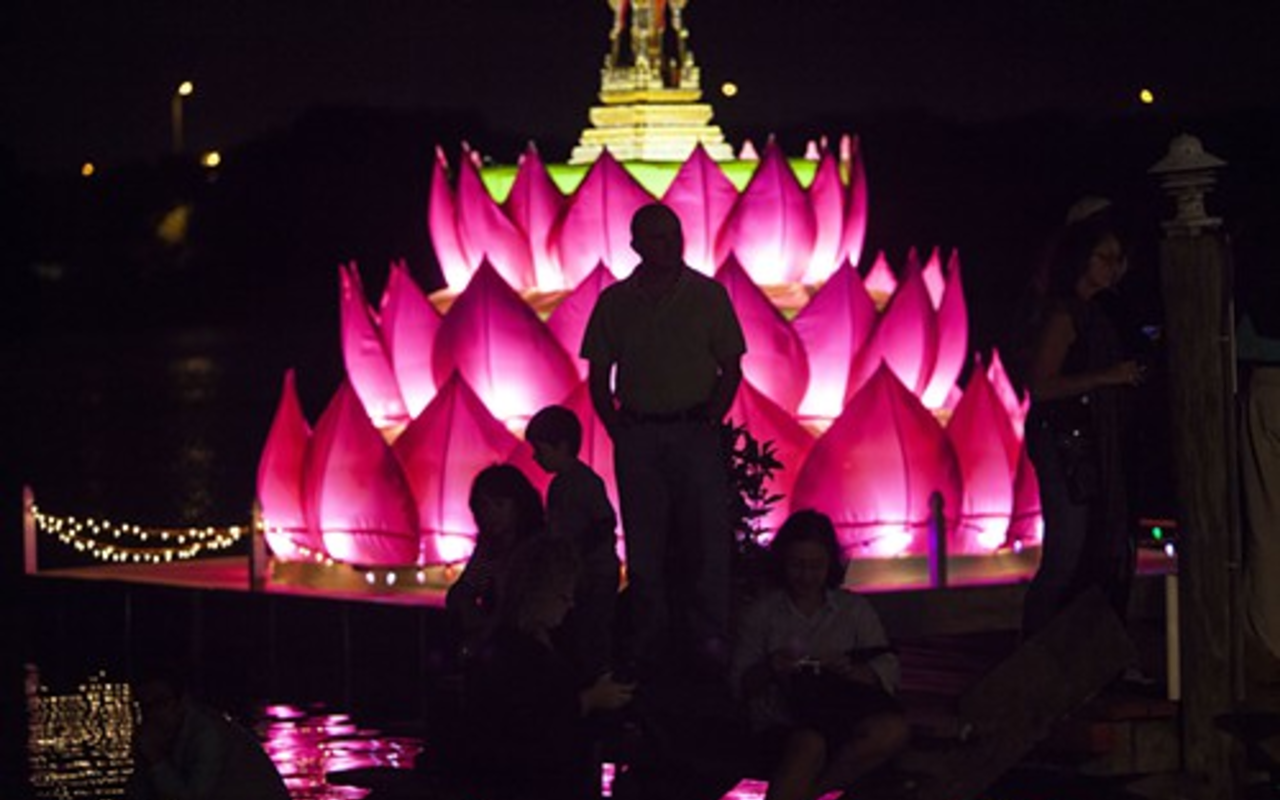Oversized krathong illuminates the Palm River as hundreds honor water