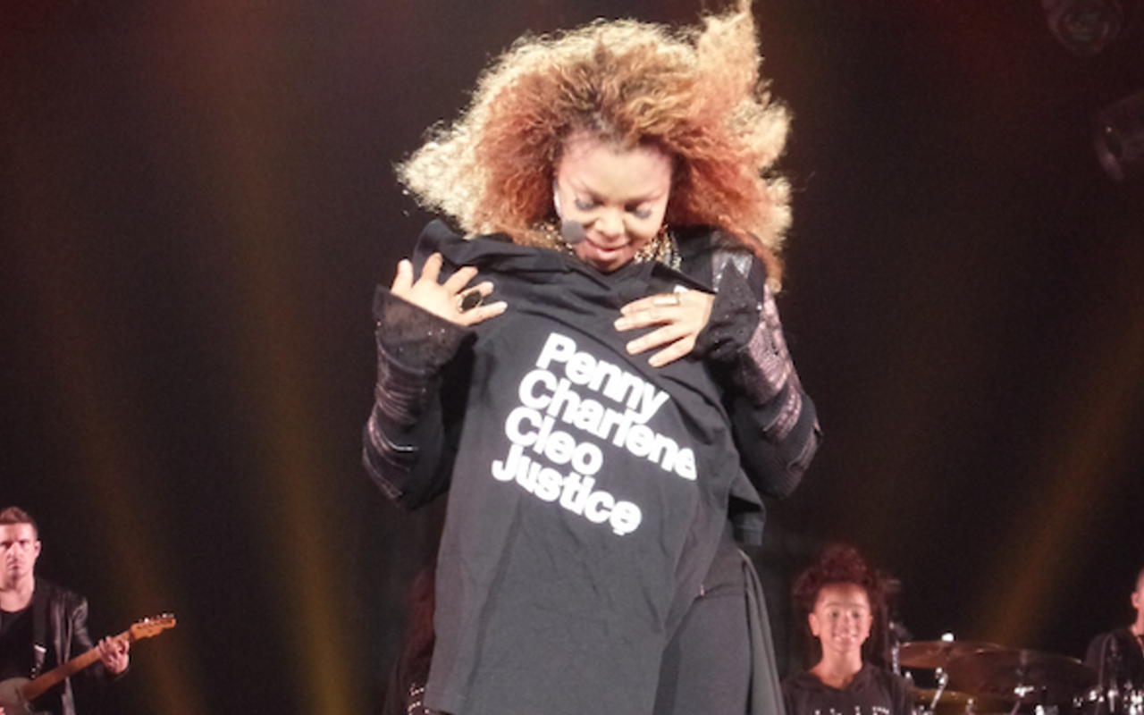 Janet Jackson receives St. Pete artist Chad Mize's t-shirt onstage during her September 24 appearance at Amalie Arena in downtown Tampa.