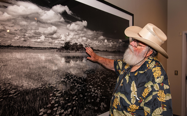Clyde Butcher points to a telling detail in his photograph, "Ochopee," at the Tampa Bay History Center.