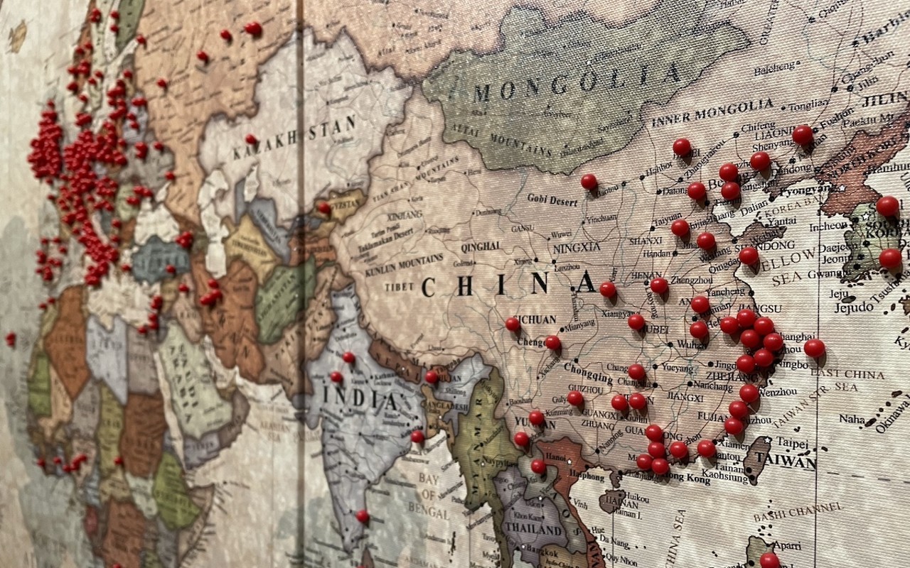 At the James Museum's ‘From Far East to Far West,' a bulletin board invite guests to visualize their ancestry by pushing red pins onto a world map.