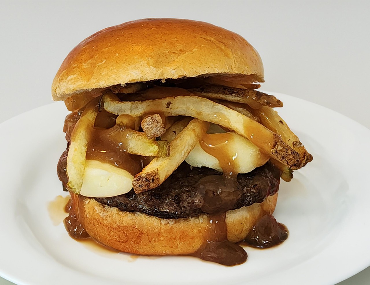 POUTINE BURGER
A flame grilled burger with fresh cut fries, warm cheese curds and topped with gravy served on a homemade bun.
DeAnna's Donut Burger