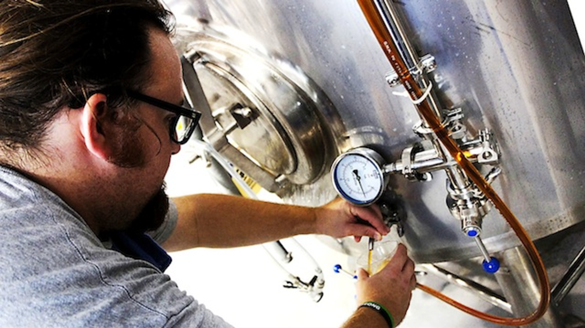 Big Storm Brewing Company's Mike Bishop pours some of their first batch of brew.