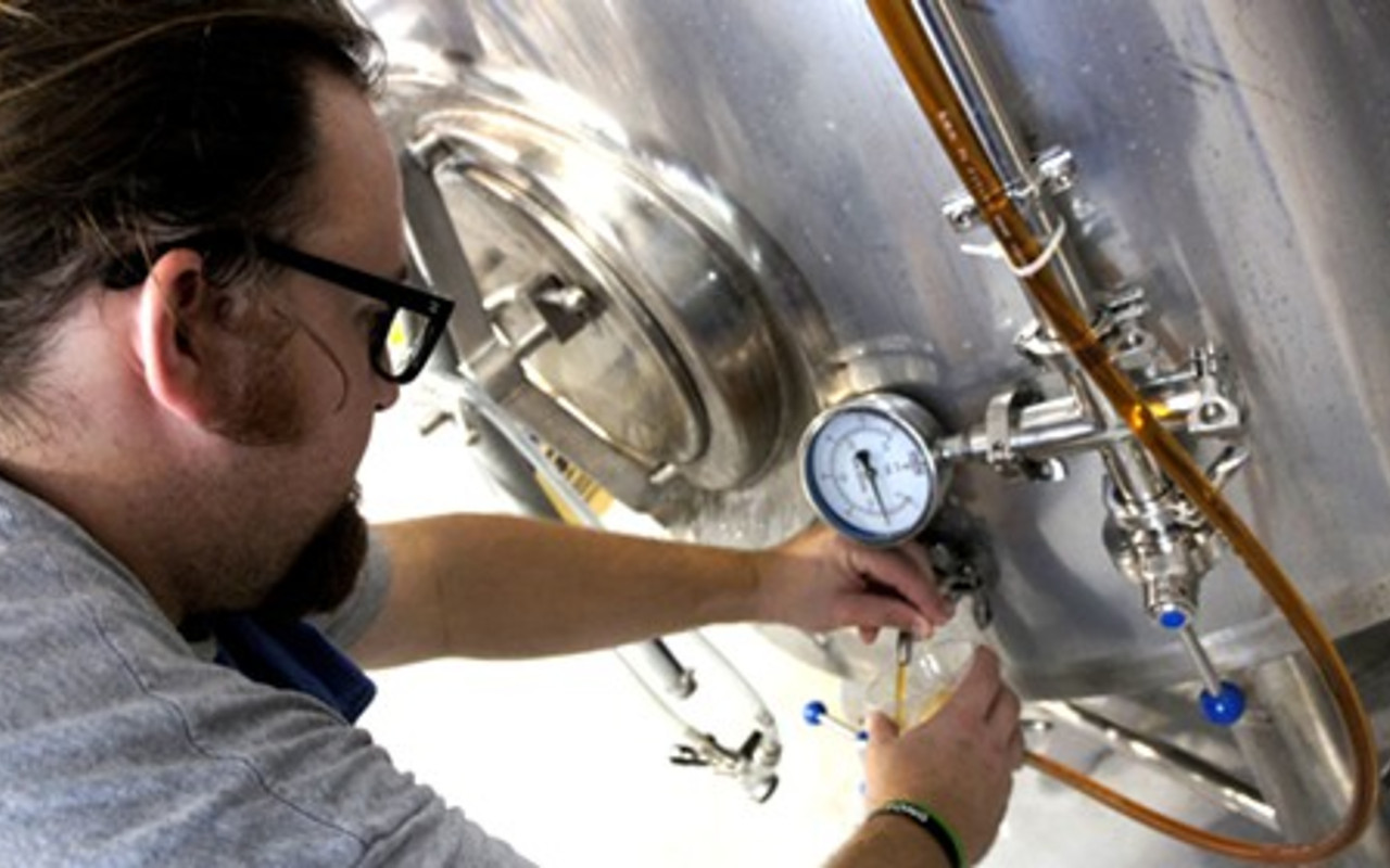 At the brewery in Odessa, head brewer Mike Bishop pours a sample from the first batch WaveMaker Amber Ale.