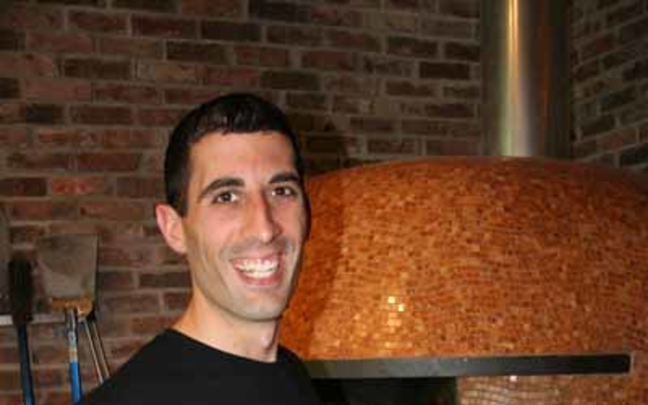 NICE PIE: Owner Dan Bavaro proudly shows off a 12-inch arugula pizza.