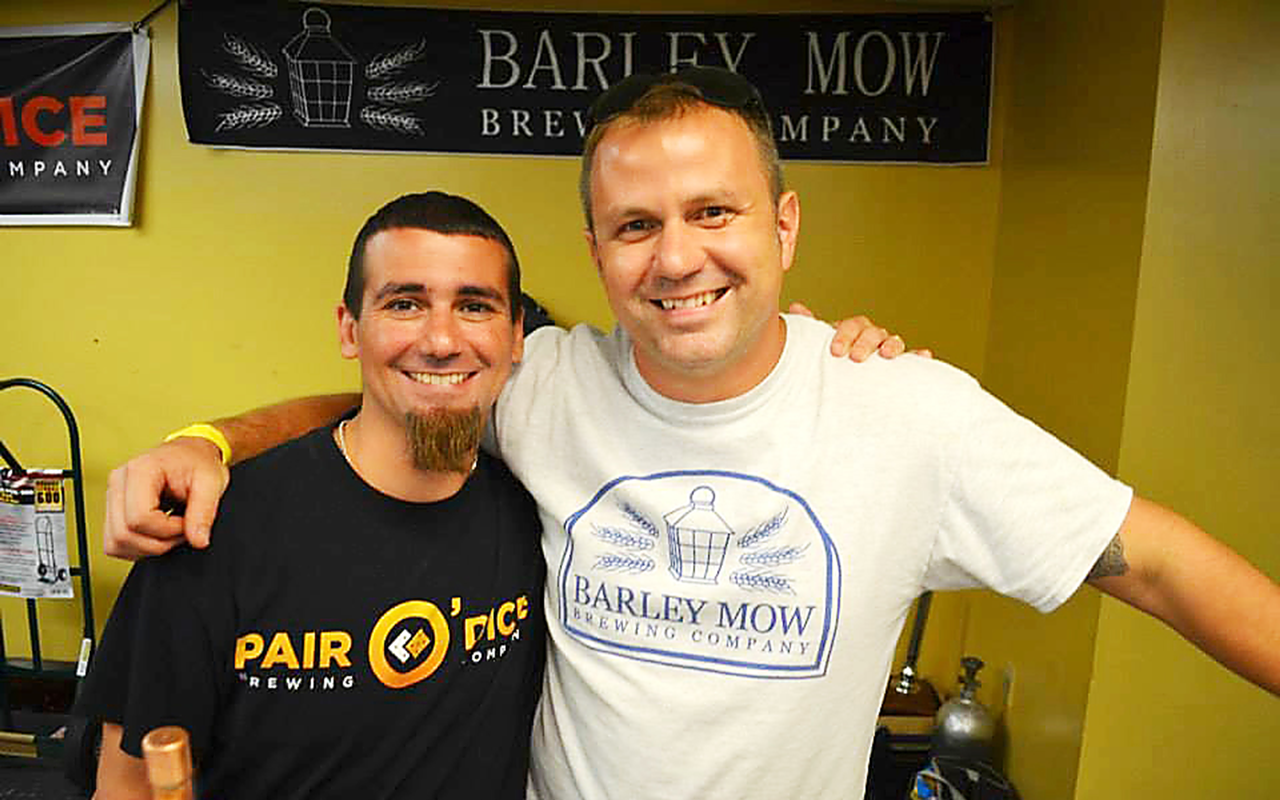 GET BY WITH A LITTLE HELP: Pair O’ Dice Brewing Co.’s Ken Rosenthal (left) with Barley Mow’s Jay Dingman at the Halfway There beer festival on Saturday.