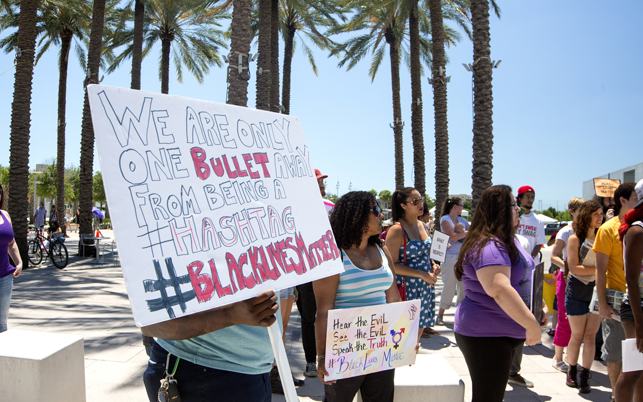 “We are only one bullet away from being a #hashtag,” read one sign during the downtown Tampa protest.
