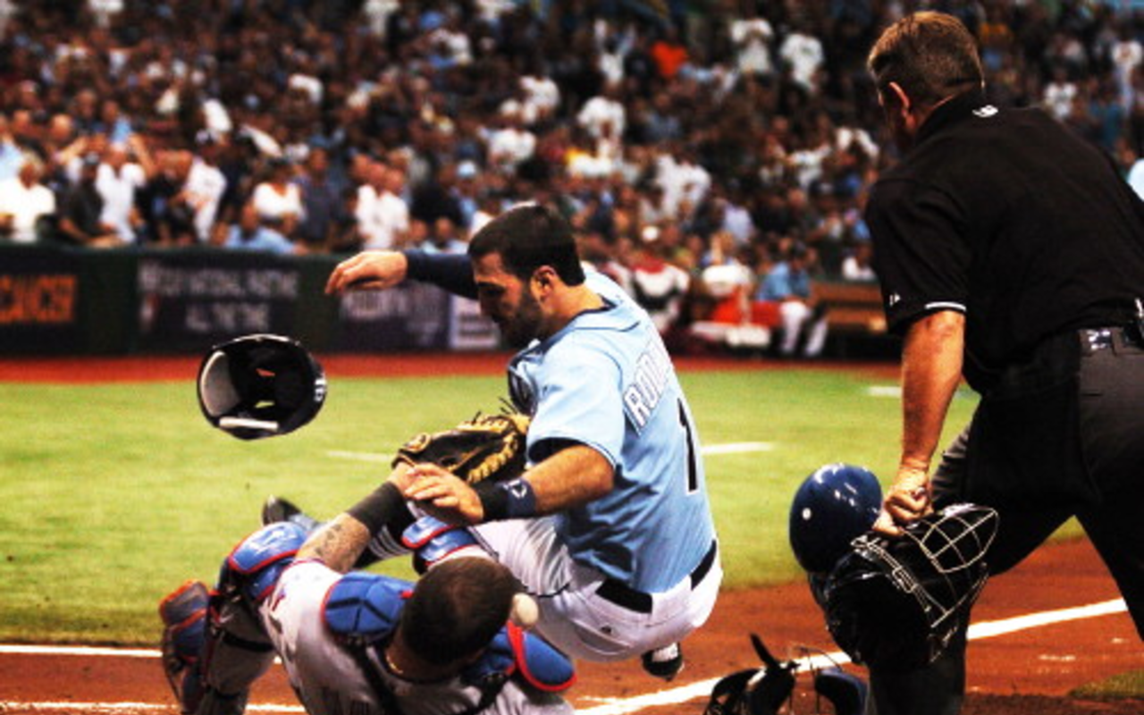 Sean Rodriguez smashes into home plate (and Rangers catcher Mike Napoli) on the way to scoring the Rays' first run.