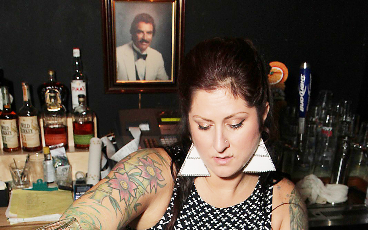 BENDING BAR: Crissy Gerow tends bar at The Bends' grand opening Saturday in St. Petersburg.