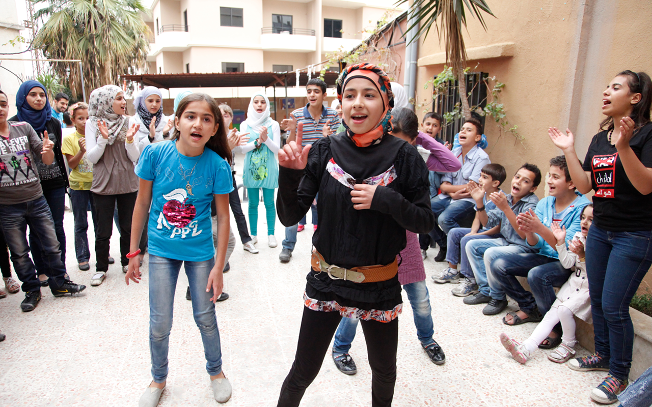 YEARNING TO BREATHE FREE: Syrian refugee children celebrate upon reaching Lebanon.