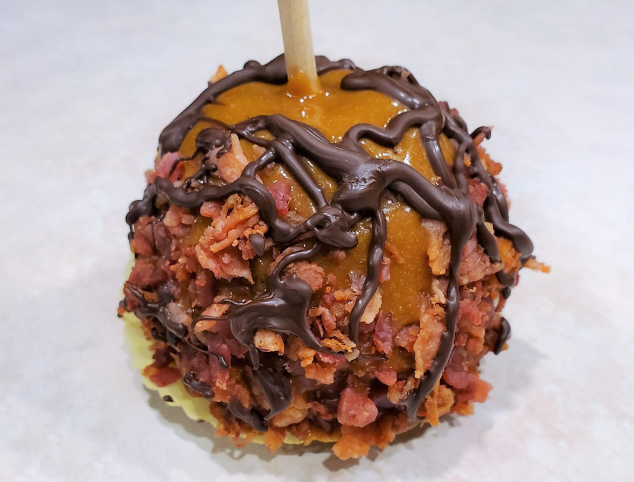 Bacon Caramel Apples           
"A crisp Granny Smith apple covered in rich house-made caramel, rolled in real bacon bits. Also available drizzled in chocolate!"                        Where to find it: The Apple Cart