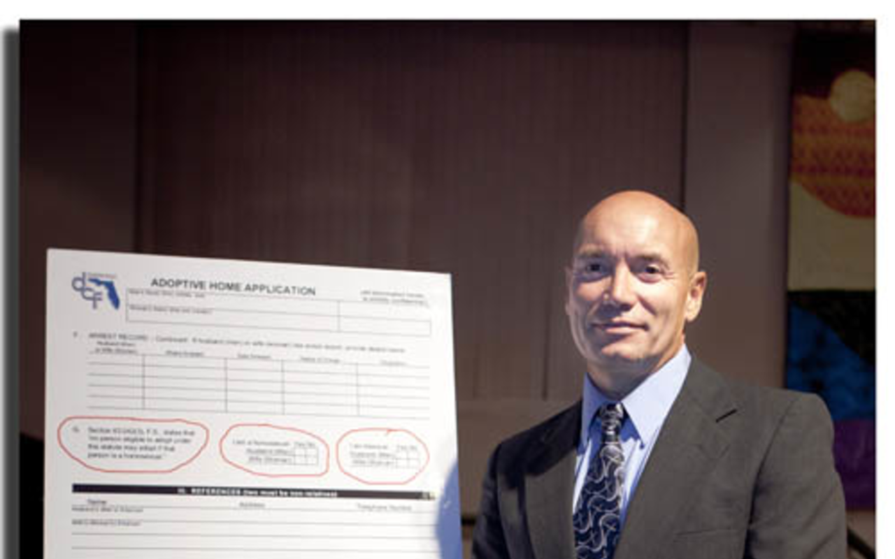 YES OR NO: Martin Gill, at a St. Petersburg forum last Friday, with the FL adoption form that asks prospective adoptive parents to declare their sexual orientation.