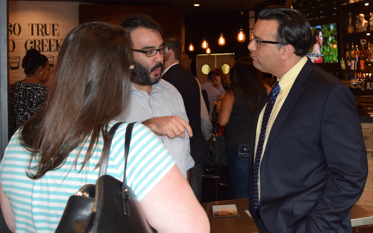 Tampa District 7 City Councilman Luis Viera (right) converses with constituents at a popular local Greek chain location restaurant in his district.