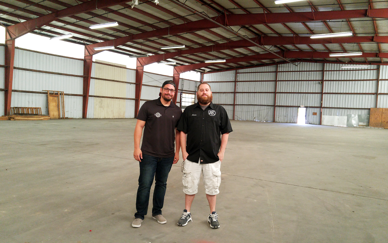 Brenden Markopoulos and Aaron Barth inside the big building that will house their brewhouse.