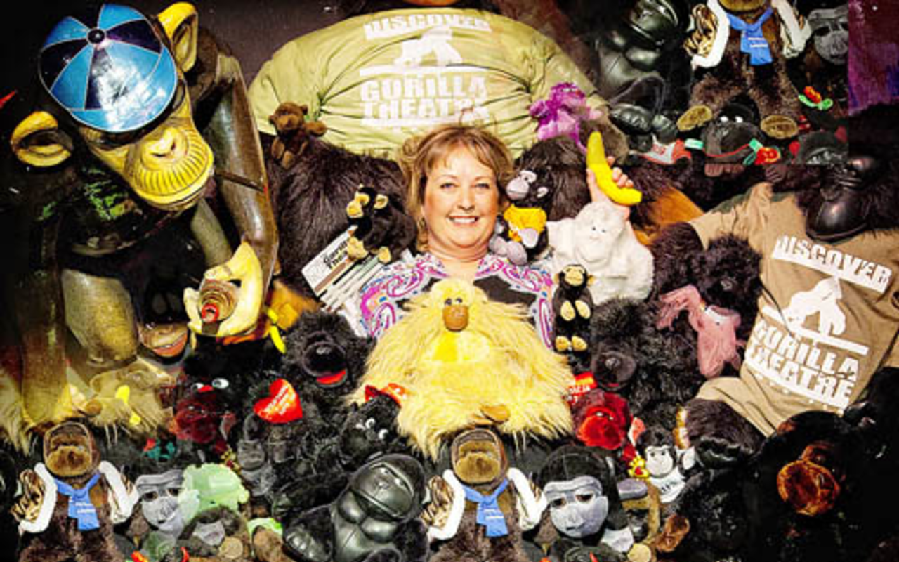 GORILLA MY DREAMS: Managing Director Bridget Bean nestled among the theater's collection of stuffed gorillas. Founder Aubrey 
Hampton named the theater after endangered primates, equating their situation with the beleaguered status of theater.