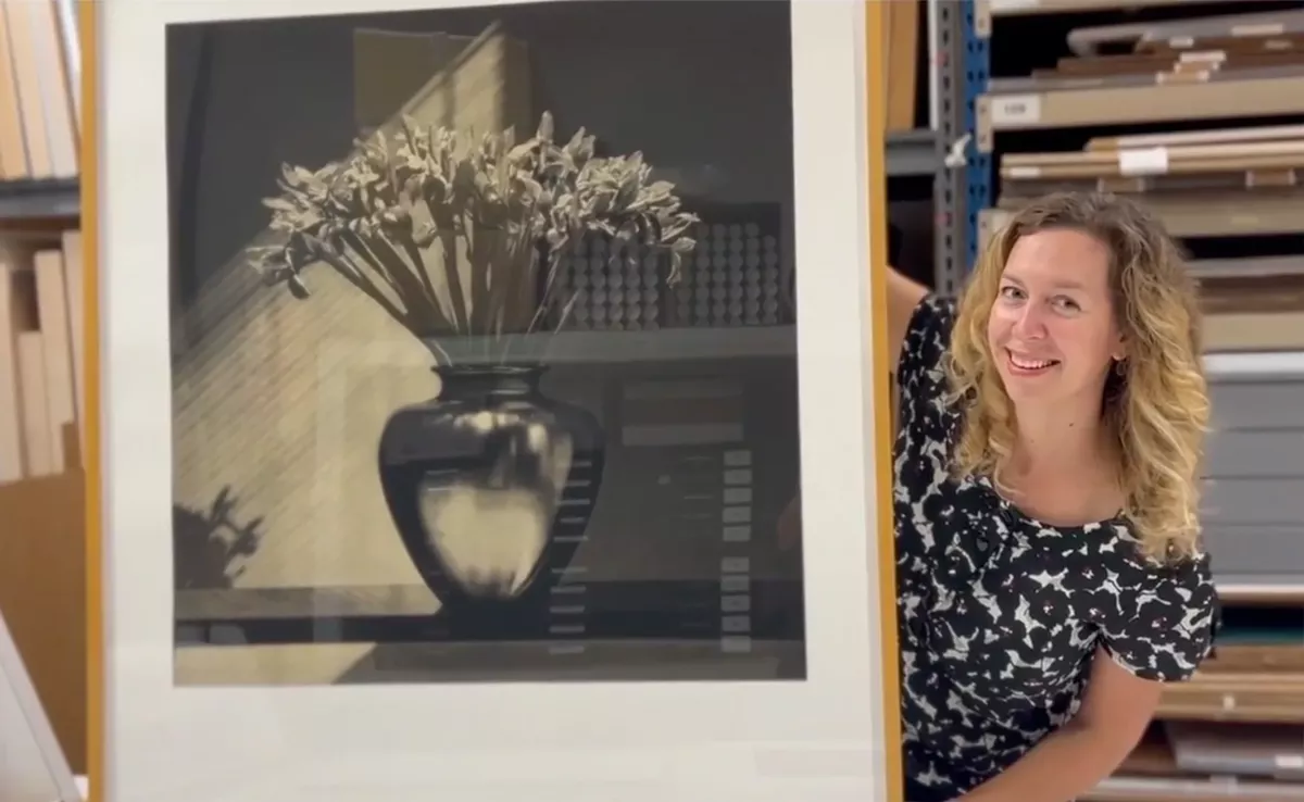 Kristin DuFrain, Curator/Registrar at Graphicstudio with a Robert Mapplethorpe, Irises.