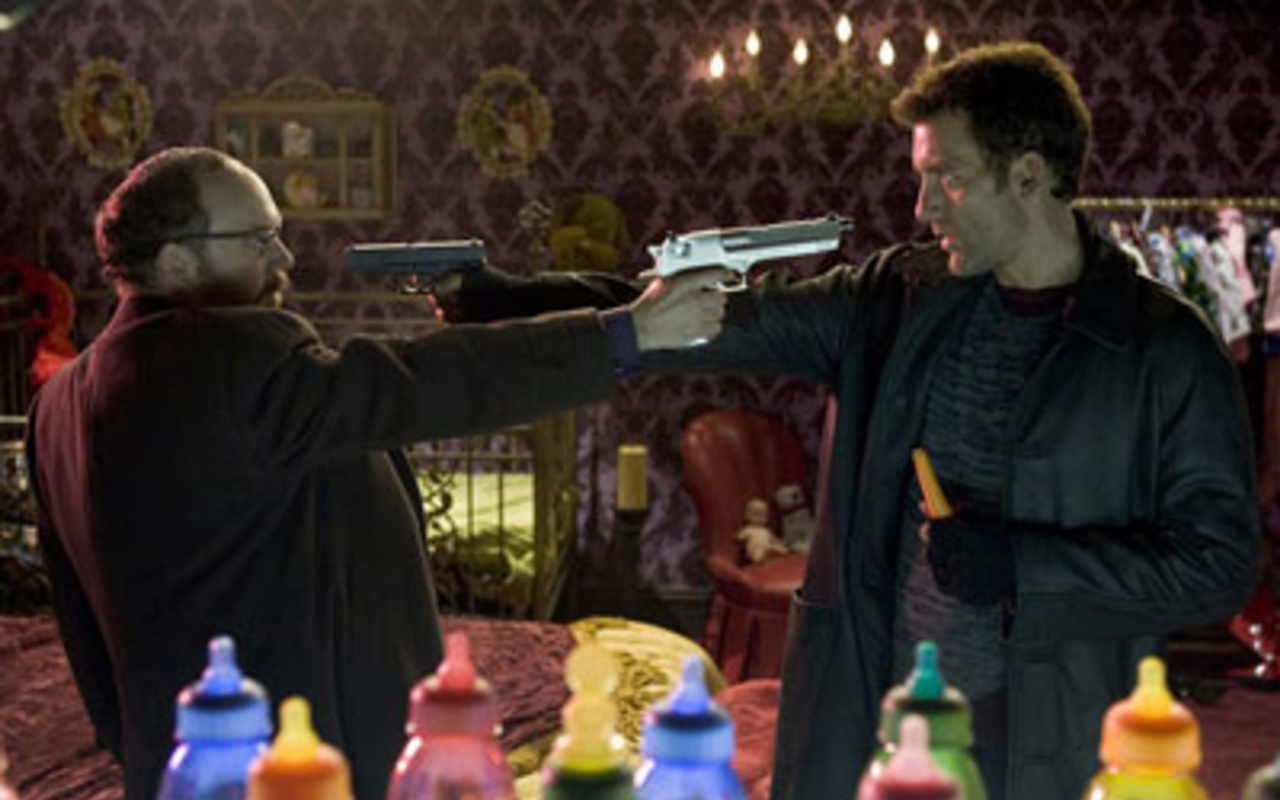 BARRELS OF FUN: Paul Giamatti and Clive Owen let their guns do the talking in Shoot 'Em Up.
