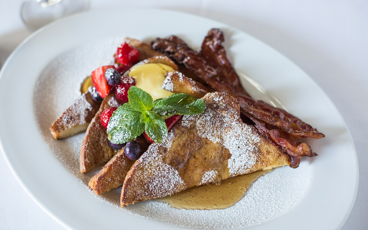 Ocean Prime's holiday French toast — fresh mixed berries, lemon curd, candied bacon and maple syrup.