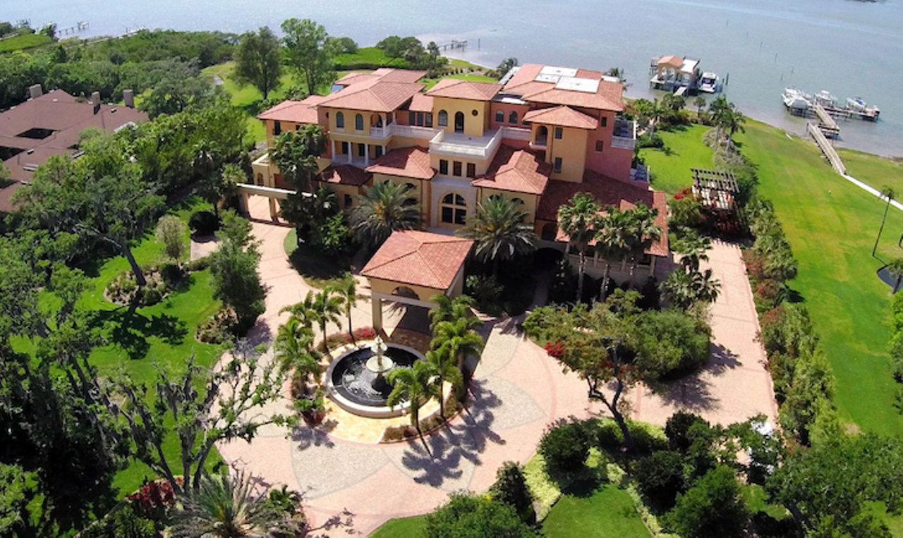 14275 Siesta Rd, Largo
$11,900,000
This 17,599 square-feet Tuscan-style estate comes with four bedrooms and nine bathrooms, and sits on 4.5-acres of land, with 247-feet of waterfront on the Intracoastal. Resting on 173 concrete pilings, the house is essentially a hurricane stopper and features windows that can sustain 175-MPH winds, a whole house generator, a solar water heater, and energy efficient appliances. The home also includes an outdoor fire pit overlooking a bordered pond, an indoor playground with a putting green, a grand salon with a two-story handmade fireplace, a two-story tall dining room, and a commercial catering kitchen. Outside, there's a guest suite, a salt water pool with Infinity edge, fountains that are surrounded by a shell stone deck, an outdoor kitchen and a boating dock.