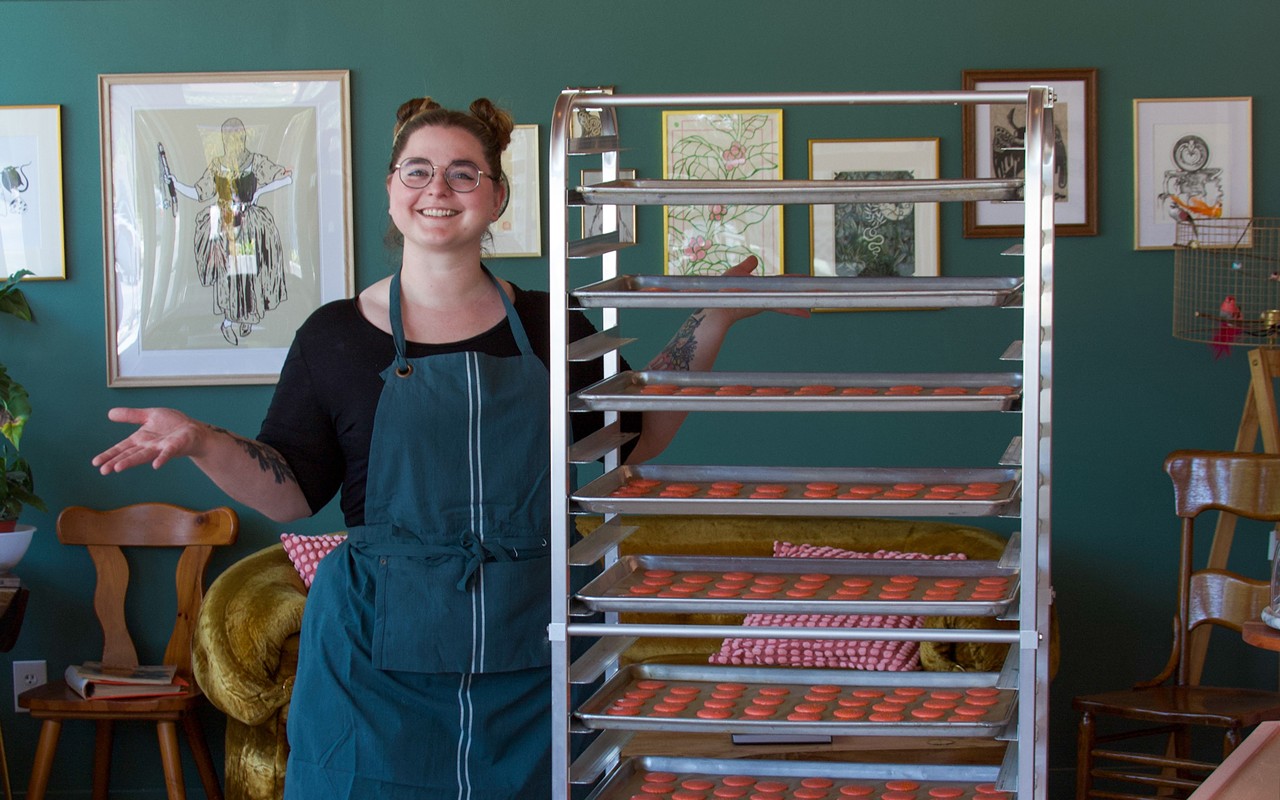 Yelvington poses with hundreds of macarons inside of her V.M. Ybor bakery.