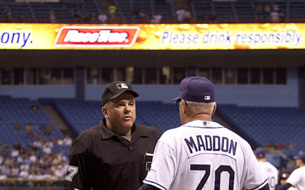 KEEPING HIS COOL: Maddon talks things over with an umpire at a recent Rays home game.