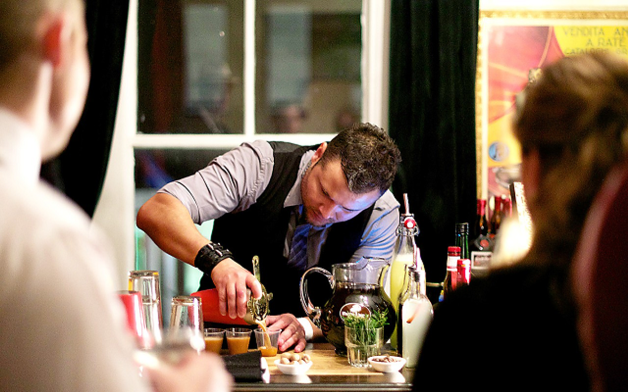 Andres Aleman mixes vintage cocktails at the Repeal Day Party in 2012.