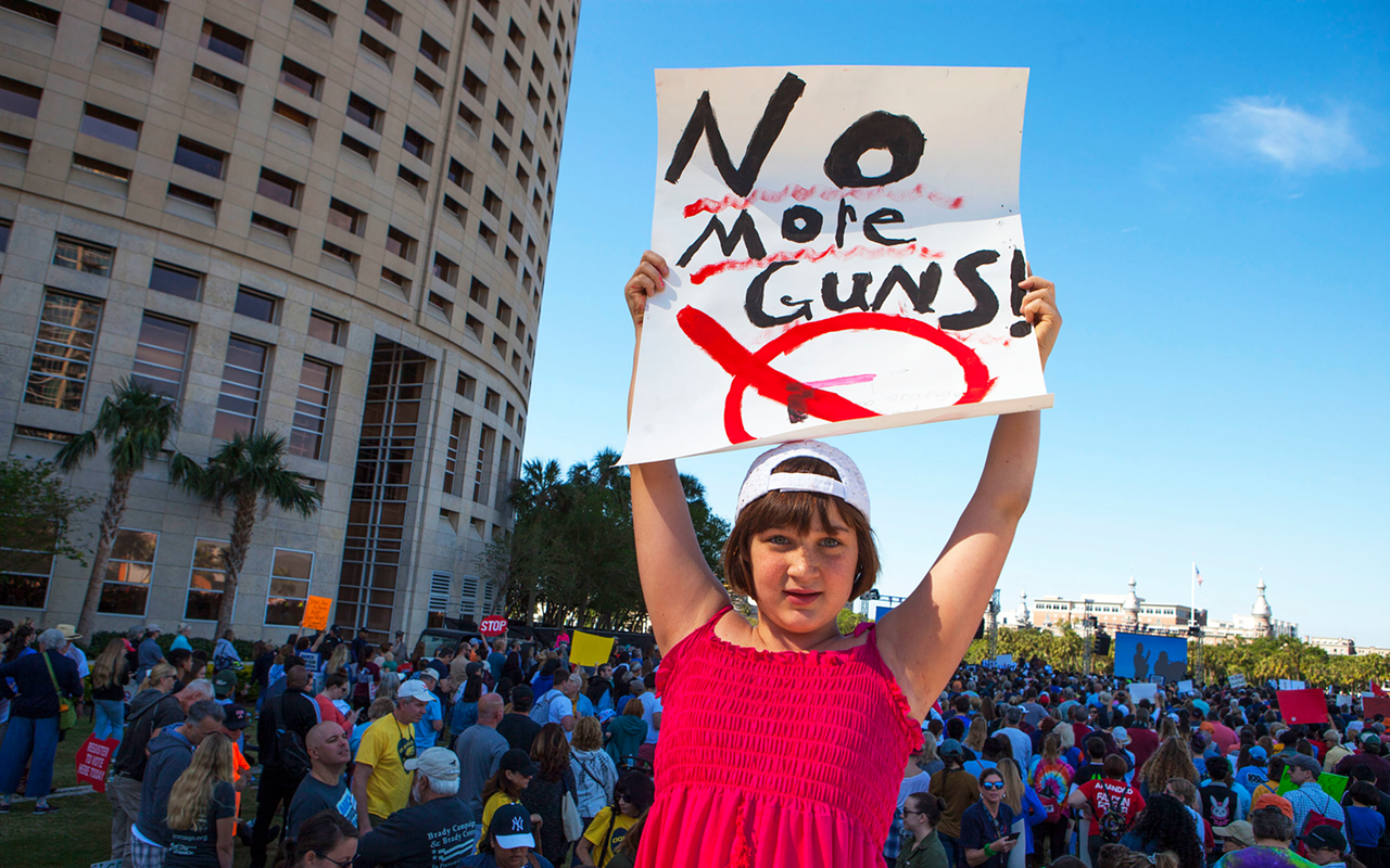 A girl holds a sign at Tampa March for our Lives.