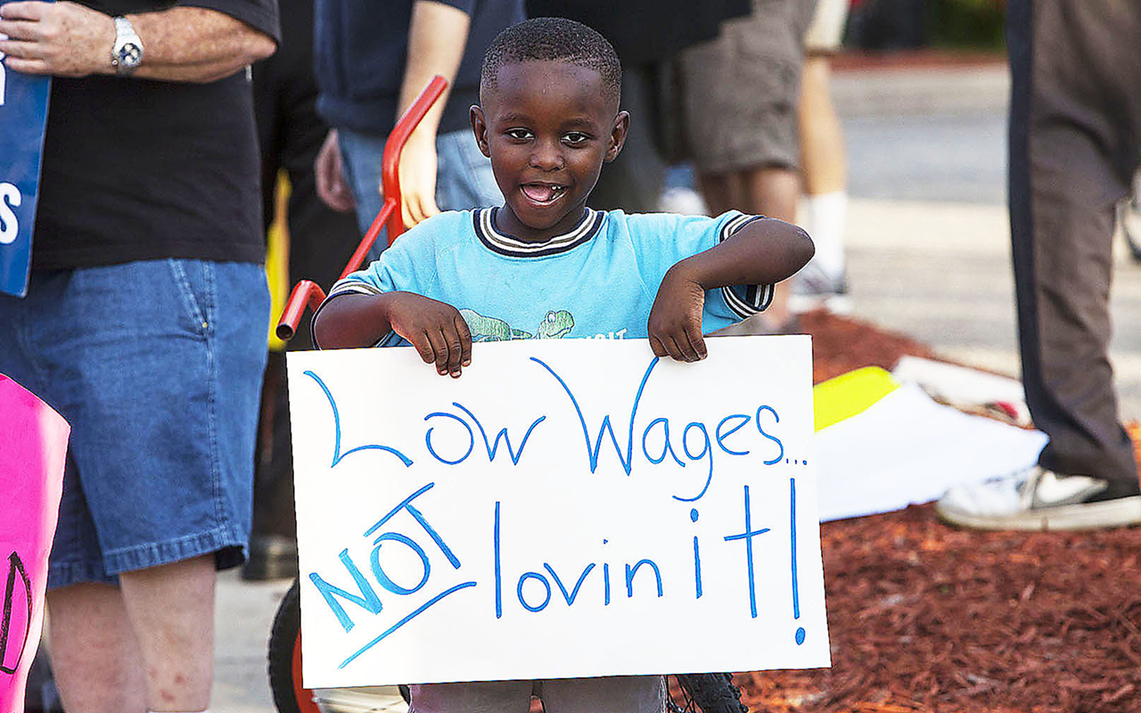 A young protester in Jan. 2014 sends a message to McDonald’s.