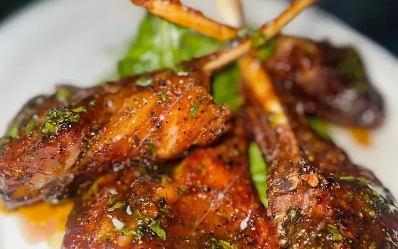 Roam's New Zealand lamb chops served with a honey garlic sauce and a citrus salad.