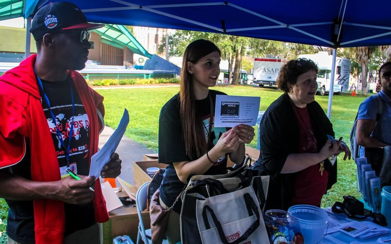 Volunteers hand out information Tuesday in Williams Park.