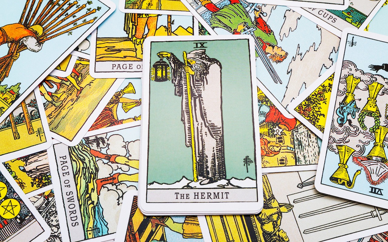 The Hermit reversed is the card guiding this spread, holding a lamp into the dark.
