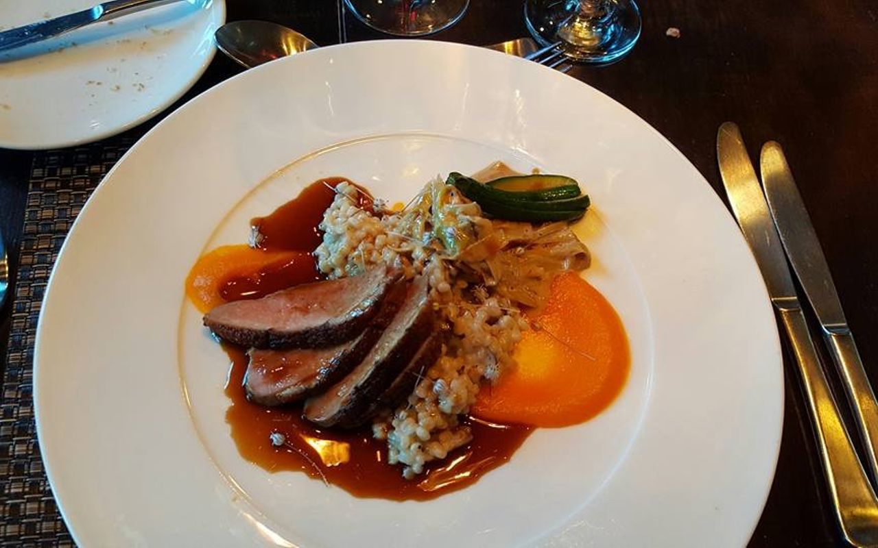 Our duck breast with ginger carrot purée, sautéd leeks, barley risotto, demi-glacé and baby zucchini.