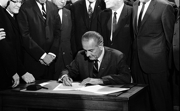 President Lyndon B. Johnson signs the Voting Rights Act.