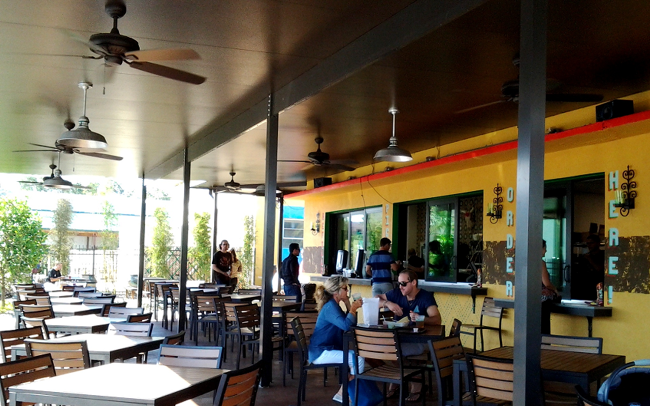 Red Mesa Mercado's burrito side and open-air dining area face Baum Avenue.