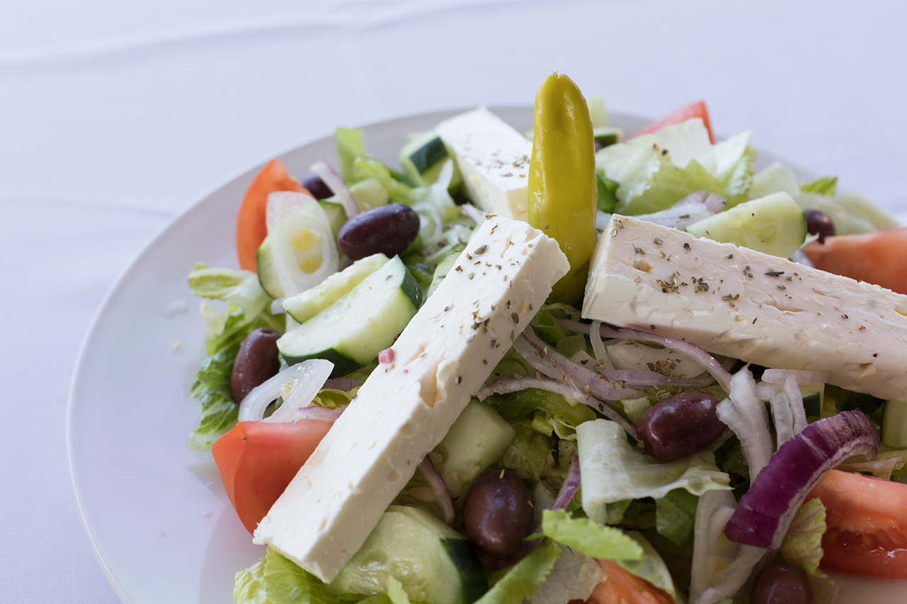 The signature Tarpon Greek salad is served on top of house-made potato salad.