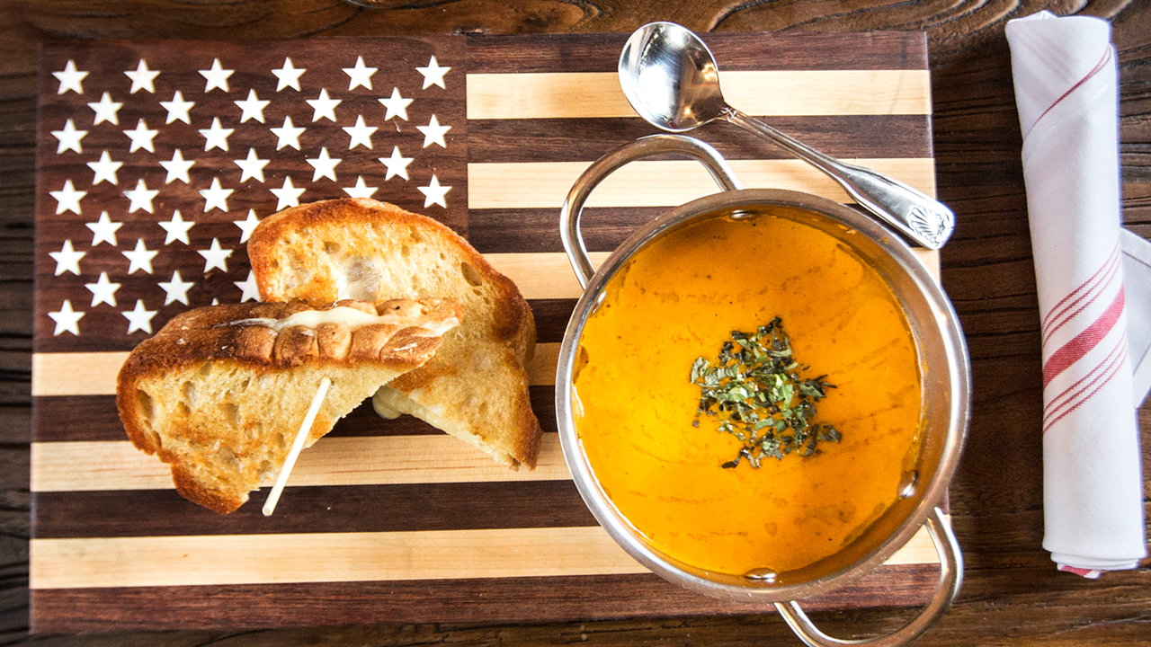 The best part about American Social's heirloom tomato soup is the Gruyère toast.