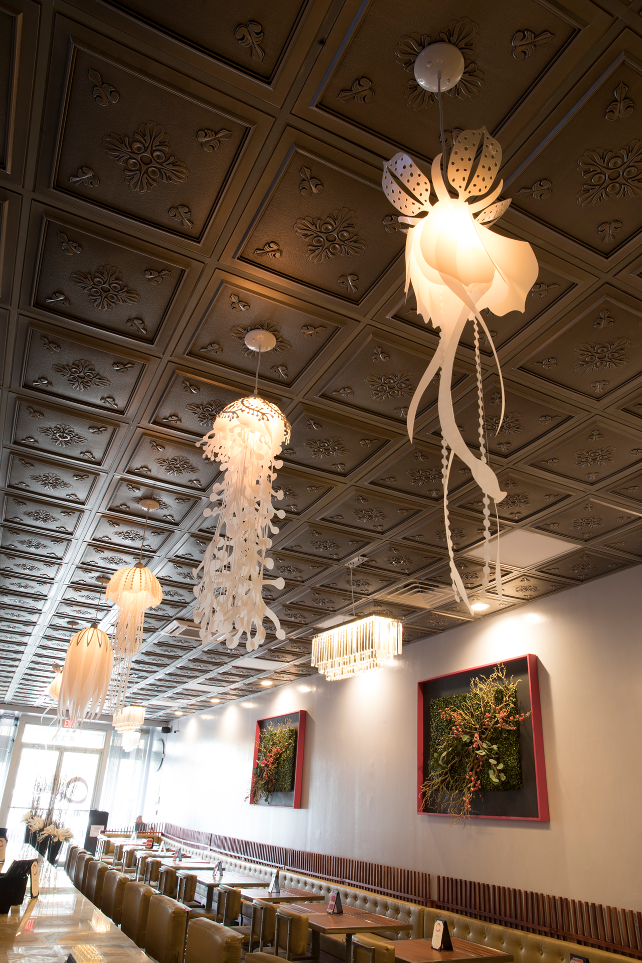 There's a series of glowing pendant lights over the bar that resemble backlit jellyfish in an aquarium.