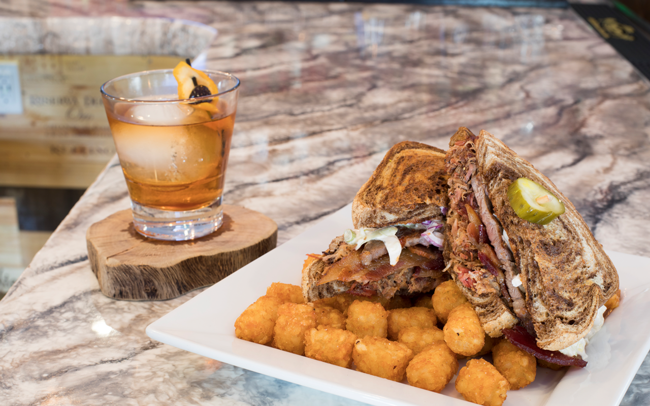 Served with a Bulleit Rye Old Fashioned, the Catcher's Rye sandwich of beef brisket, pork, candied whiskey bacon, beer cheese and slaw on marble rye.