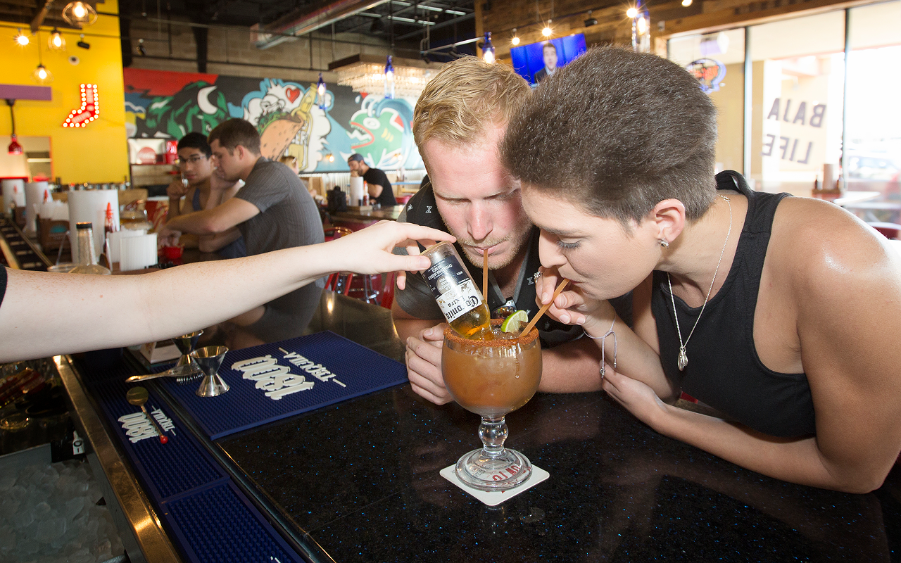 Justin Boss and Kayleigh Stanley drink a Fuzzy's Blood of the Bull Beer-Rita, a house-styled Bloody Mary infused with a split of beer.