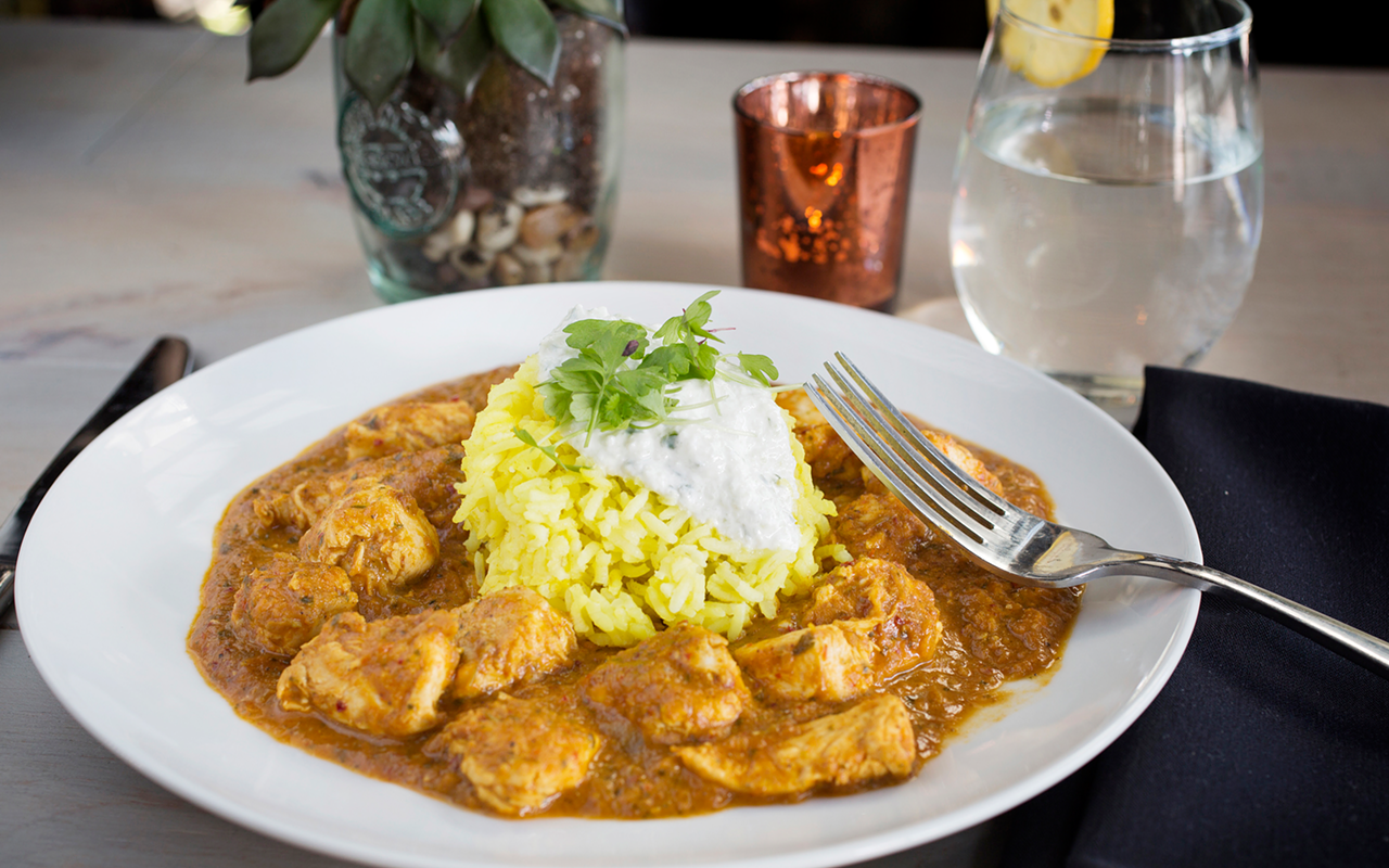 Iberian Rooster's Goan cafreal with green and red curry sauce, coconut milk, cucumber yogurt and basmati.
