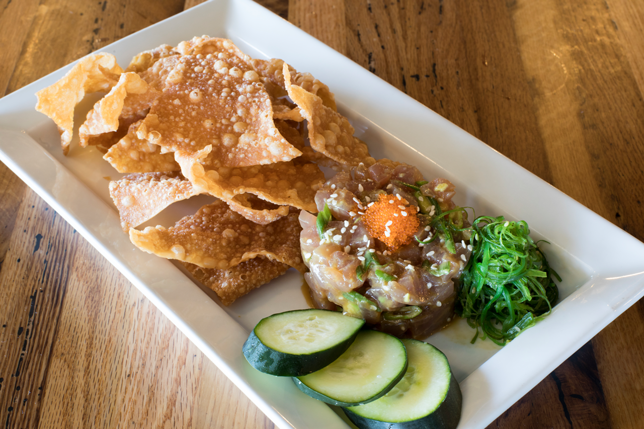 Ahi tuna poke is a ring of sushi-grade tuna tossed with avocado in a dressing of soy, sesame and lime — plus sea salt and tobiko roe.