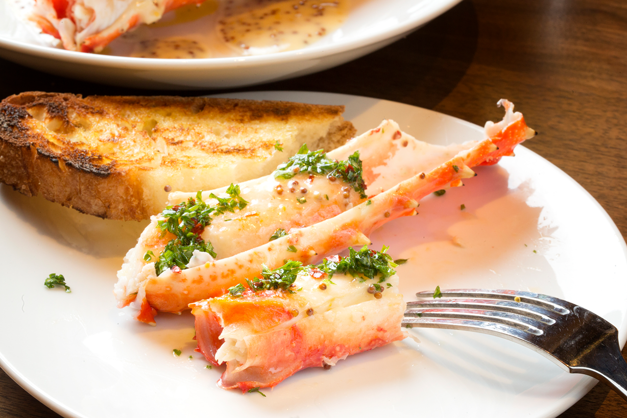 Grilled king crab legs feature grainy mustard, butter and chimichurri.