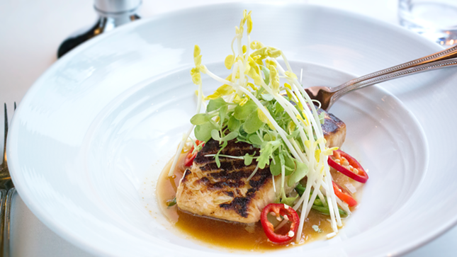 Eddie V's seared Alaskan halibut is meant for an earthy miso broth with sugar snap peas and shiitake mushrooms.