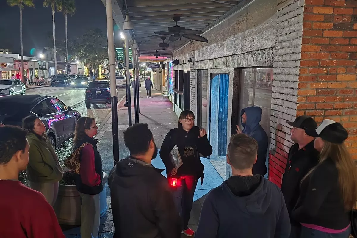 Cynthia Dominick, founder of Silent Slayer Ghost Tours, leading a ghost tour in downtown Safety Harbor, Florida.