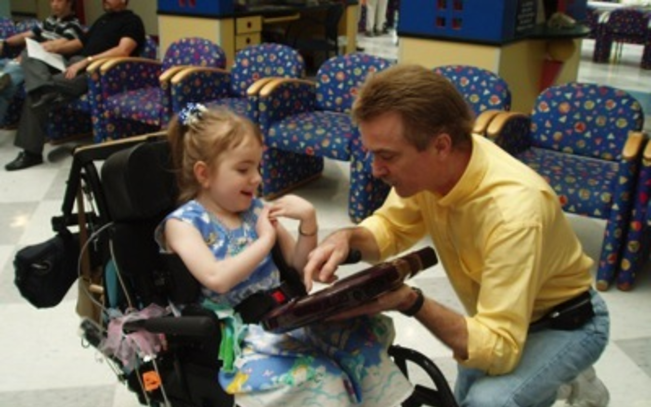 Q TIPS: Ted Wagner shows Linda, a patient at St. Joseph's Children's Hospital, how to play her Q-Chord.