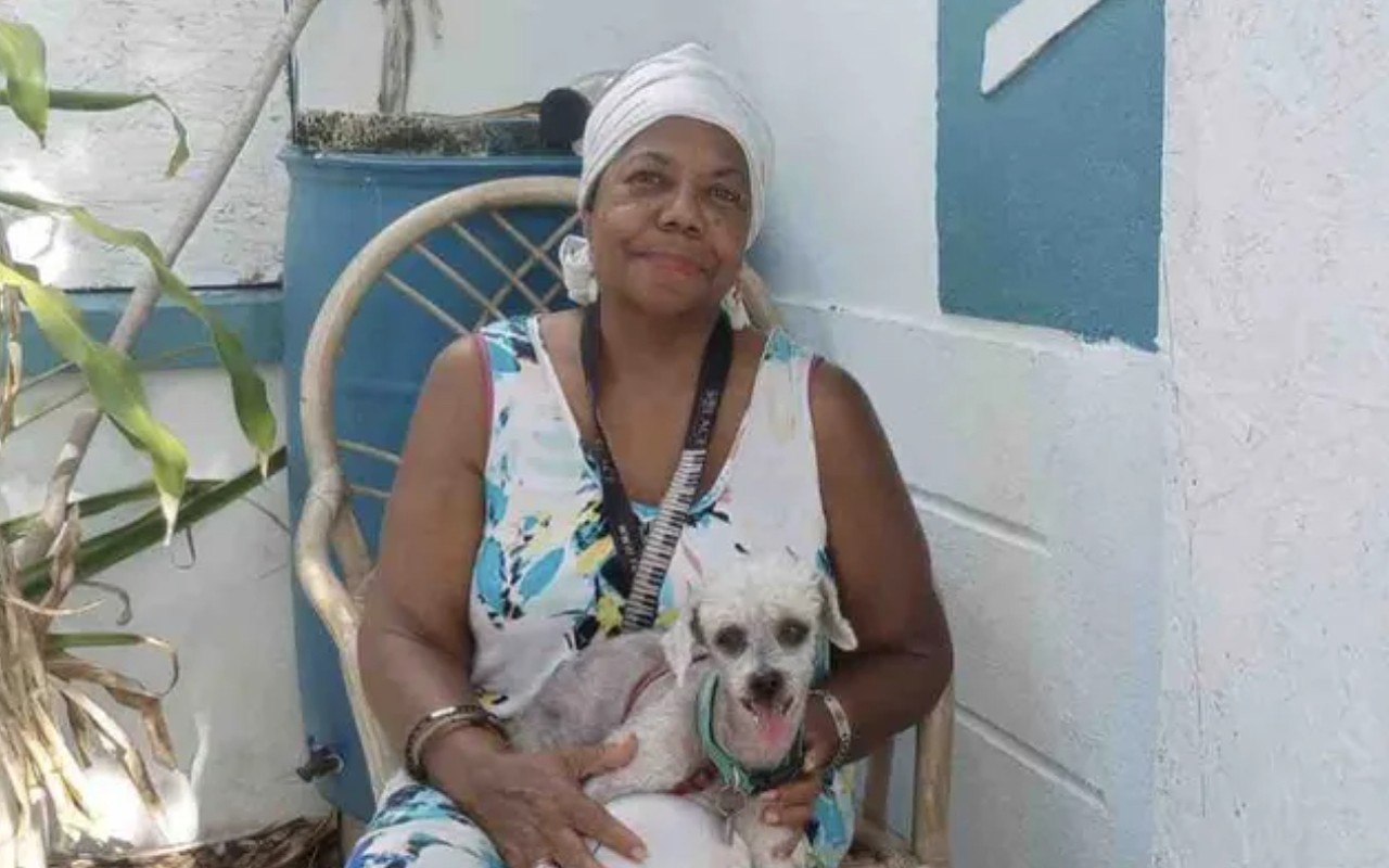 Gloria Francine Maxwell, with one of her dogs, which died in a house fire on June 23, 2022.